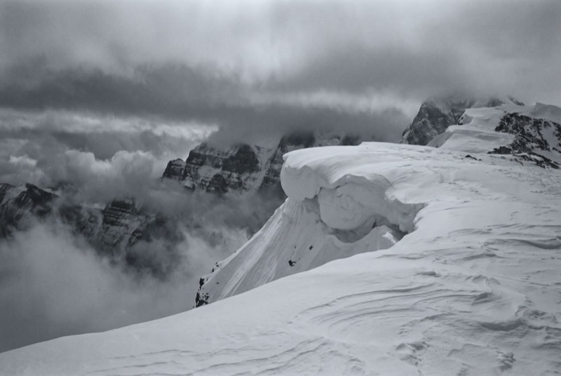 The wind-scoured corniced ridge of Baruntse under low cloud, empty of people